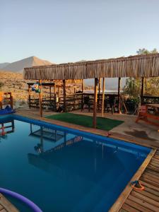 a swimming pool with a pavilion and a picnic table at Casona Mamalluca in El Durazno
