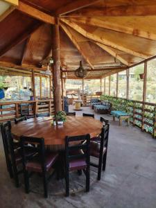 a large wooden table and chairs in a pavilion at Casona Mamalluca in El Durazno
