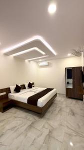 a bedroom with a large bed in a room at SKB Suites in Mysore