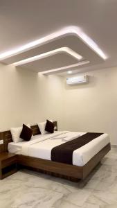 a bedroom with a large bed in a room at SKB Suites in Mysore