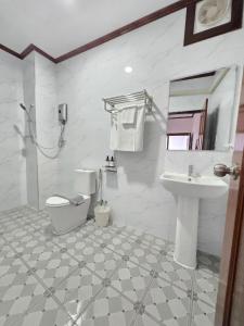 a bathroom with a toilet and a sink at Villa ThreeD Xaydara in Luang Prabang