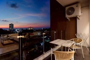a balcony with a table and chairs on a building at Seaview Residence Karon beach in Karon Beach