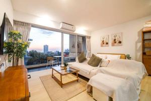 a living room with a couch and a large window at Seaview Residence Karon beach in Karon Beach +41 photos