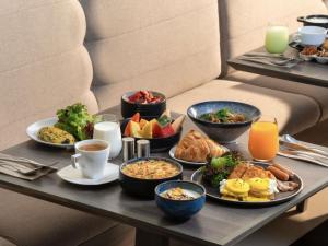 a tray of breakfast foods on a table at ibis Bangkok Siam in Bangkok