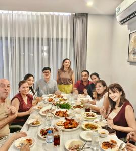 a group of people sitting around a table eating food at Pool villa Cream Darin in Ban Hua Phrong