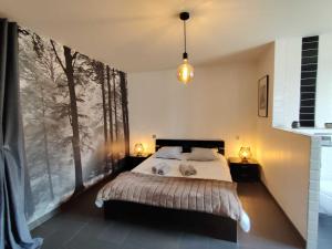 a bedroom with a bed and a large window at Gîte d'olympe in Graffigny-Chemin