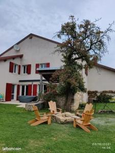 a group of chairs sitting in front of a house at Gîte d'olympe in Graffigny-Chemin