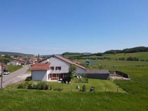 a house in the middle of a green field at Gîte d'olympe in Graffigny-Chemin +23 photos