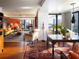 a living room with a couch and a table at Mandarin Oriental, Bangkok in Bangkok