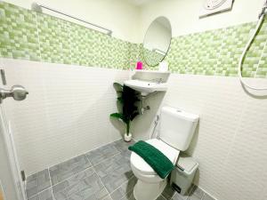 a bathroom with a toilet and a sink and a mirror at Tiny Secret in Ban Tai