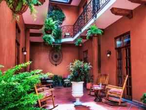 a courtyard with chairs and plants in a building at La Isabela Suites in Panama City