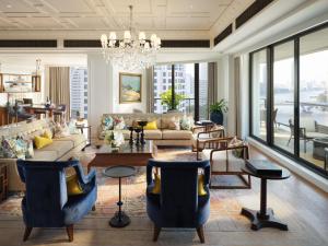 a living room with furniture and a chandelier at Mandarin Oriental, Bangkok in Bangkok