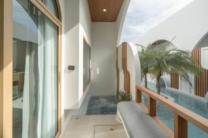 a view from the balcony of a house with a swimming pool at De Lunar Kohlarn in Ko Larn