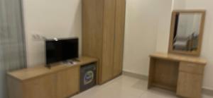a room with a flat screen tv on a stand at AVS Nội Bài Hotel in Sóc Sơn