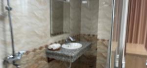 a bathroom with a sink and a shower at AVS Nội Bài Hotel in Sóc Sơn +9 photos