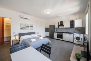 a large room with two beds and a kitchen at Rubiera Residence - H24 in Zimella