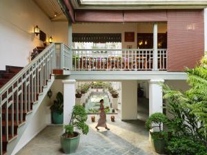 a woman walks through the lobby of a building at Mandarin Oriental, Bangkok in Bangkok +164 photos