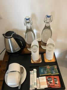 a table with two bottles of water and a tea kettle at Saffron Lake Yala in Tissamaharama