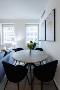 a living room with a table and chairs at Stylish NYC Haven Steps to Broadway & Dining in New York