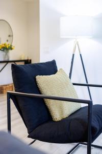 a blue chair with a pillow in a living room at Stylish NYC Haven Steps to Broadway & Dining in New York