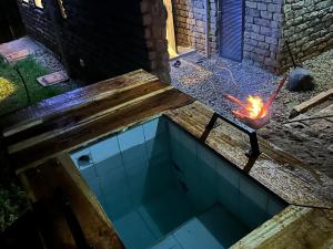 a swimming pool with a fire in a pot at Kapto Camp in Kapchorwa +3 photos