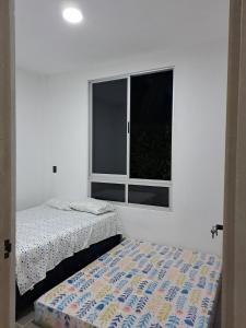 a bedroom with a bed and a window at Finca Villeta in Villeta