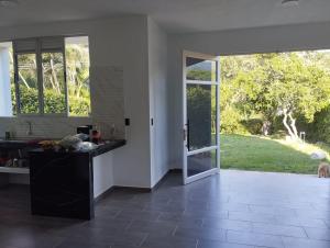 a kitchen with a large glass door to a yard at Finca Villeta in Villeta