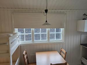 a table and chairs in a kitchen with a window at Edsken Camping in Hofors