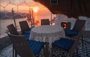 a table and chairs with a table and a fireplace at Yeosu 48 Hour Pool Villa in Yeosu