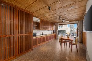 a kitchen and dining room with a table and chairs at LUK Inn Hotel - An Thuong, Da Nang in Danang