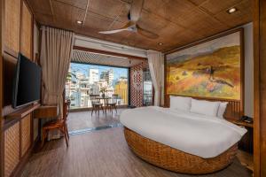 a hotel room with a large bed and a tv at LUK Inn Hotel - An Thuong, Da Nang in Danang