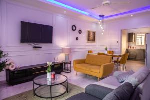 a living room with a couch and a table at The View Apartments Salagi in Brusubi