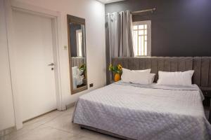 a bedroom with a large bed with white pillows at The View Apartments Salagi in Brusubi