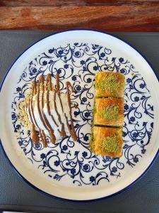 a blue and white plate with two pieces of food at CURIOCITY Green Point in Cape Town