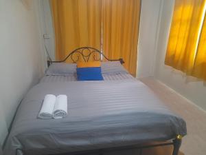 a bed with two slippers on it in a room at บ้านโสภา in Ko Phi