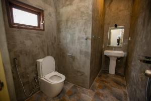 a bathroom with a toilet and a sink at The Lux Villa in Habaraduwa Central +17 photos