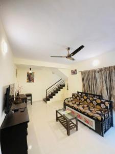 a living room with a bed in the middle of a room at Between The Raindrops in Lonavala