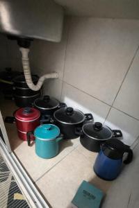 a group of pots and pans on a kitchen floor at Casa Refúgio Tamandaré in Tamandaré