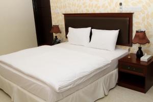 Postel nebo postele na pokoji v ubytování Dar Al Khaleej Hotel Apartments