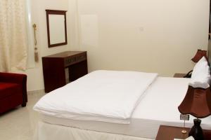 Postel nebo postele na pokoji v ubytování Dar Al Khaleej Hotel Apartments