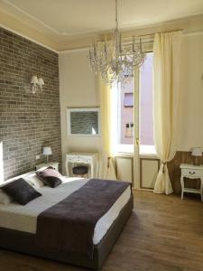 a bedroom with a large bed and a large window at Maglo Centro in Bologna