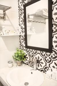 a bathroom with a sink and a mirror at Khách Sạn Nhơn Lý LYS HOTEL in Quy Nhon