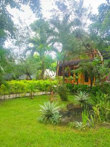 a bus in a garden with plants and trees at Triple J Villa in Sekongkang Bawa