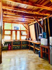 a kitchen with wooden counters and a large window at Triple J Villa in Sekongkang Bawa