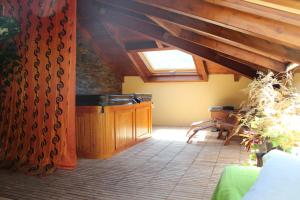 a living room with a skylight and a table and chairs at Casa Coll in Barruera