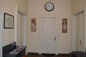 
a room with a clock on the wall and a clock on the wall at Valentina Apartments in Prague
