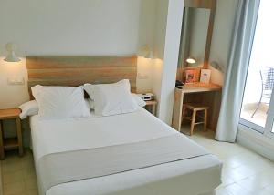 Łóżko lub łóżka w pokoju w obiekcie Hotel Boutique Elvira Plaza