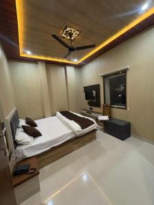 a bedroom with a bed and a television in it at Hotel Riverviewinn in Varanasi
