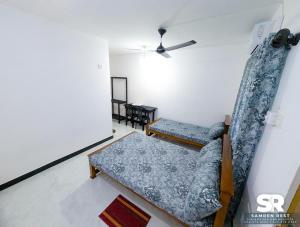 a living room with a couch and a table at Samren Rest in Hambantota