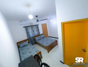 a small room with two chairs and a table at Samren Rest in Hambantota